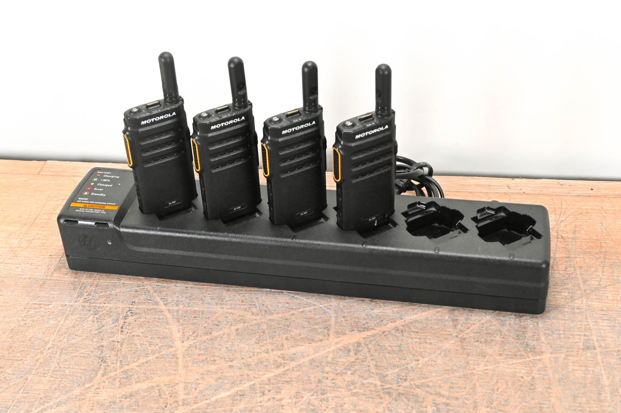 Motorola PMLN7093A Multi-Unit Charger with four SL300 Two-Way Radios